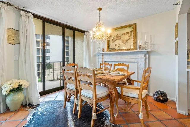 a view of a dining room with furniture and a chandelier