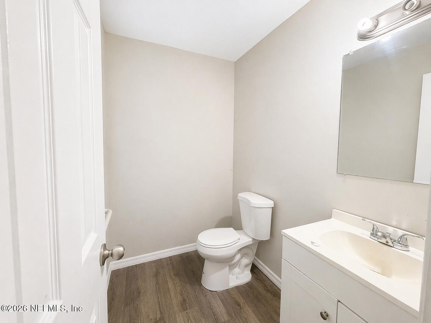 874 West 12th Street St. Augustine, FL 32084 - Photo 11 of 29 a white toilet sitting next to a bathroom sink