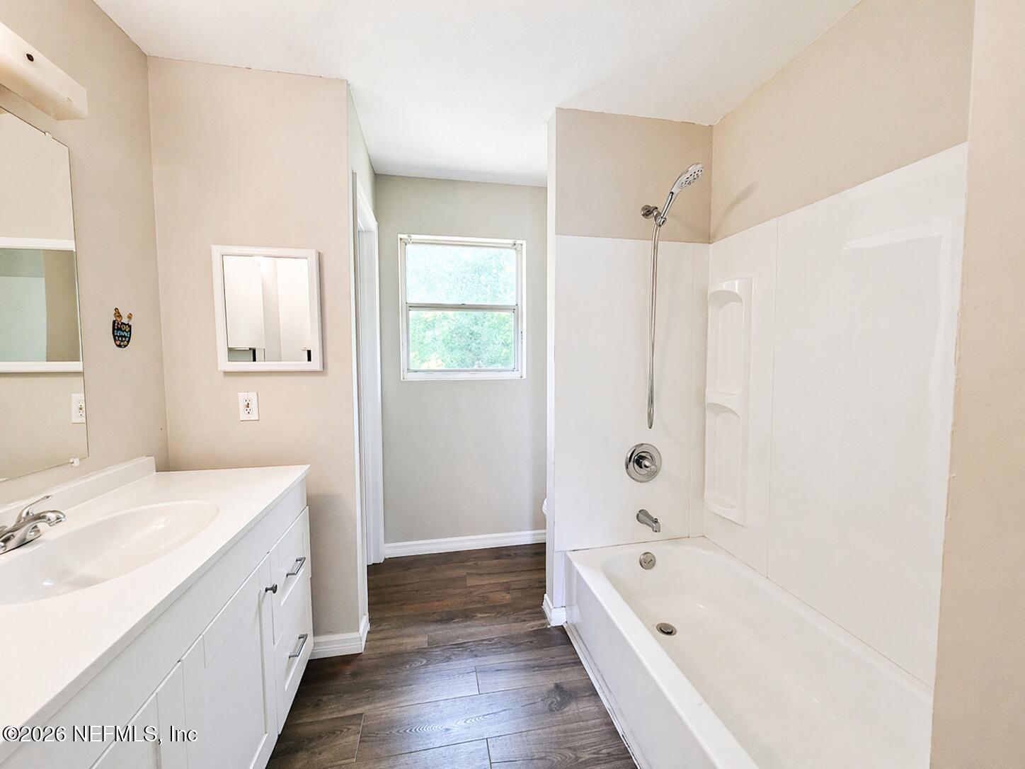 874 West 12th Street St. Augustine, FL 32084 - Photo 12 of 29 a bathroom with a tub a sink and a large mirror