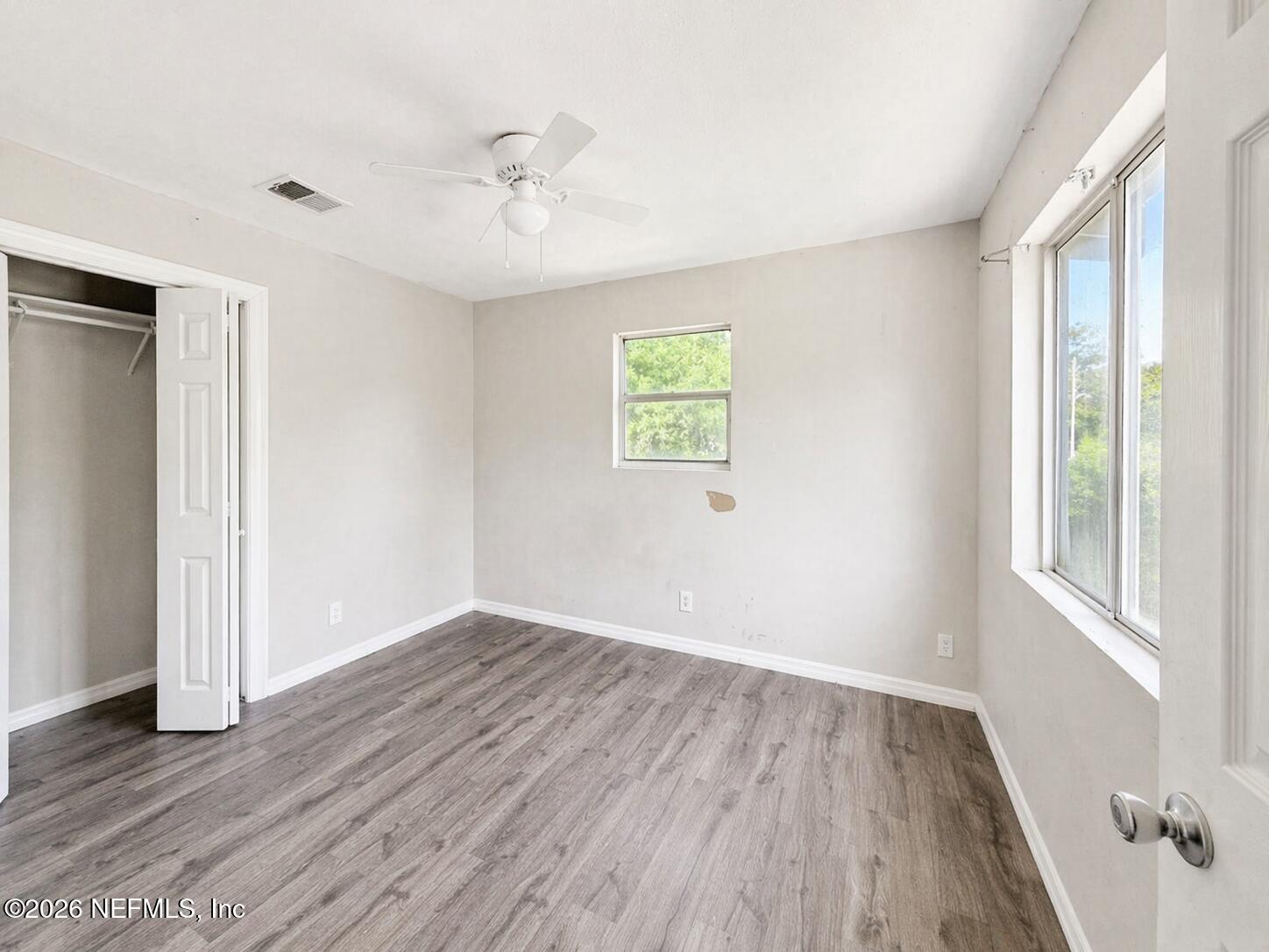 874 West 12th Street St. Augustine, FL 32084 - Photo 15 of 29 a view of an empty room with wooden floor and a window