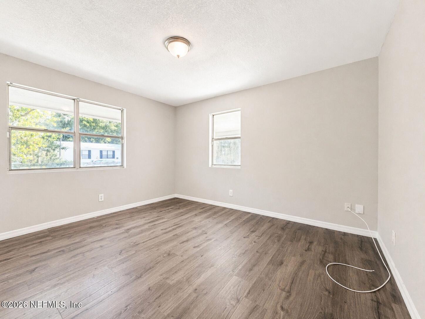874 West 12th Street St. Augustine, FL 32084 - Photo 17 of 29 an empty room with wooden floor and windows