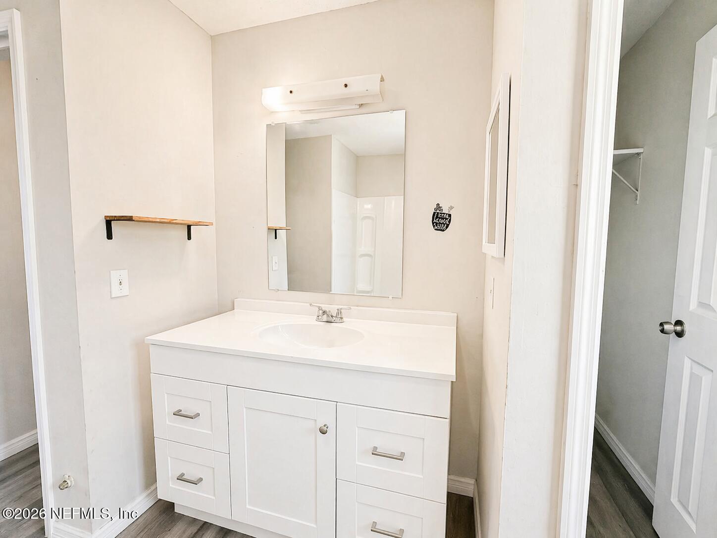 874 West 12th Street St. Augustine, FL 32084 - Photo 19 of 29 a bathroom with a sink vanity granite and a mirror