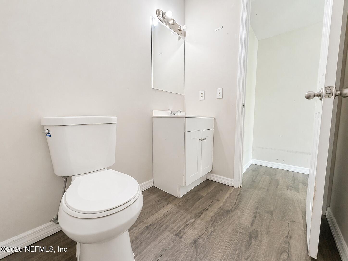 874 West 12th Street St. Augustine, FL 32084 - Photo 26 of 29 a white toilet sitting next to a bathroom sink