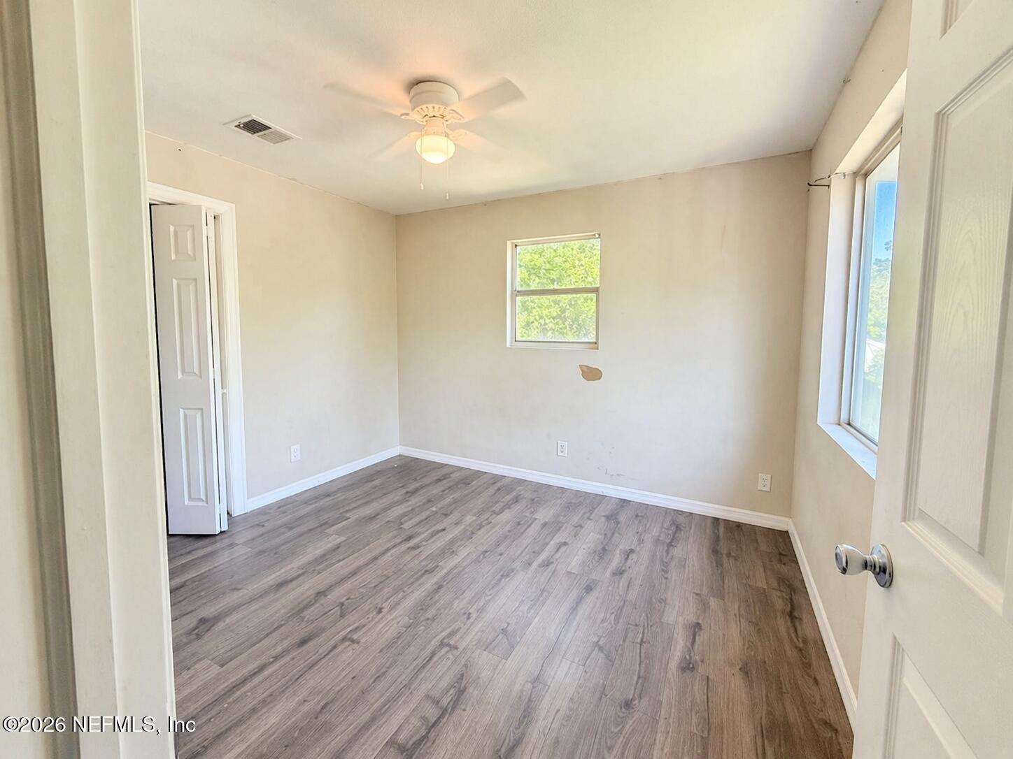 874 West 12th Street St. Augustine, FL 32084 - Photo 27 of 29 an empty room with wooden floor and windows