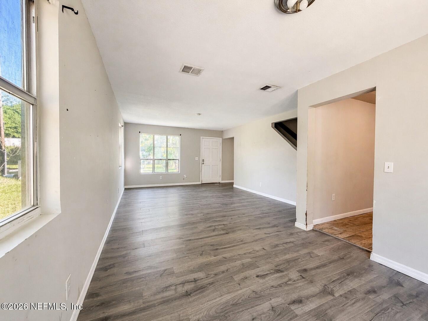 874 West 12th Street St. Augustine, FL 32084 - Photo 28 of 29 a view of an empty room with wooden floor and a window