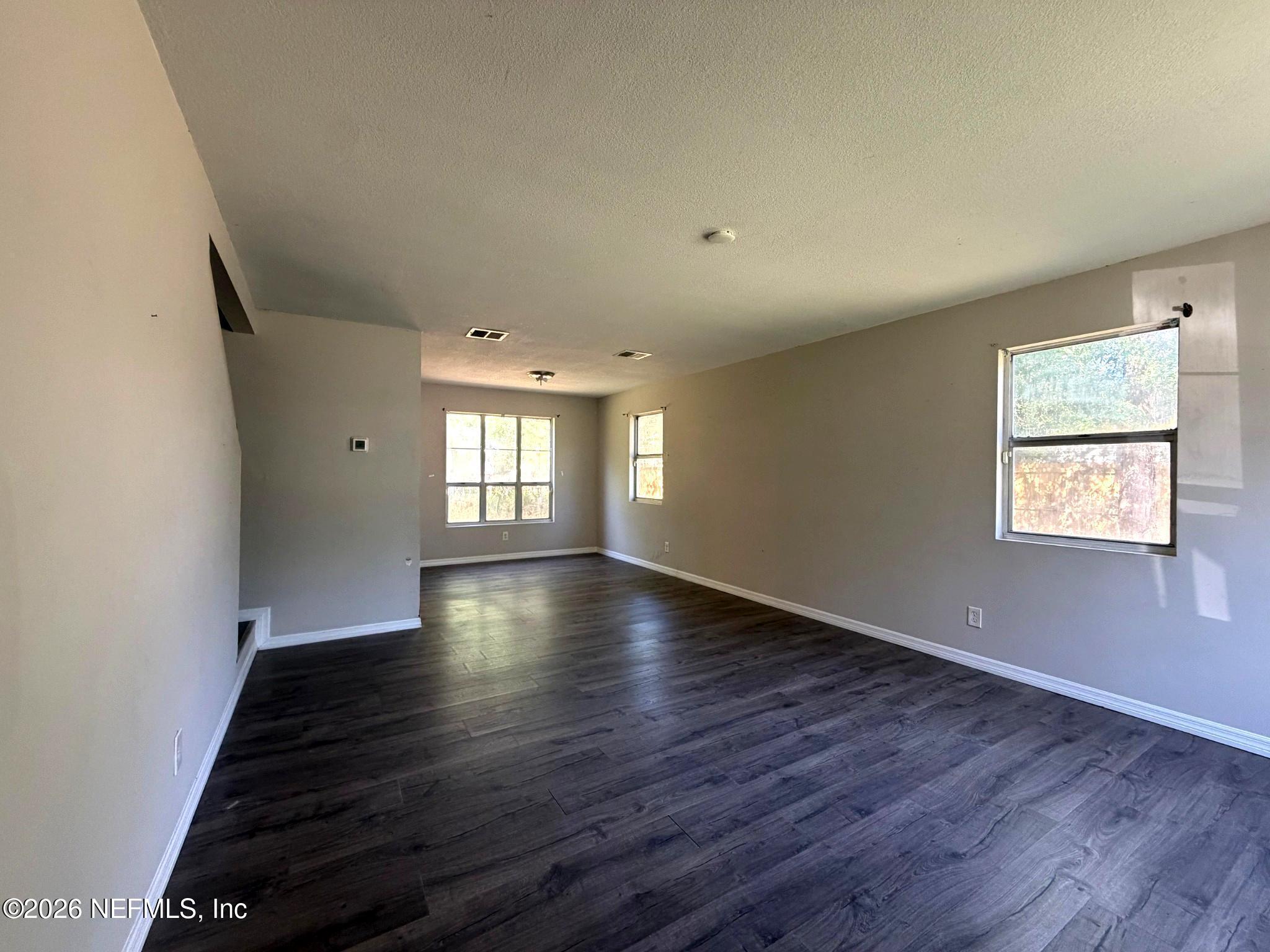 874 West 12th Street St. Augustine, FL 32084 - Photo 29 of 29 an empty room with wooden floor and windows