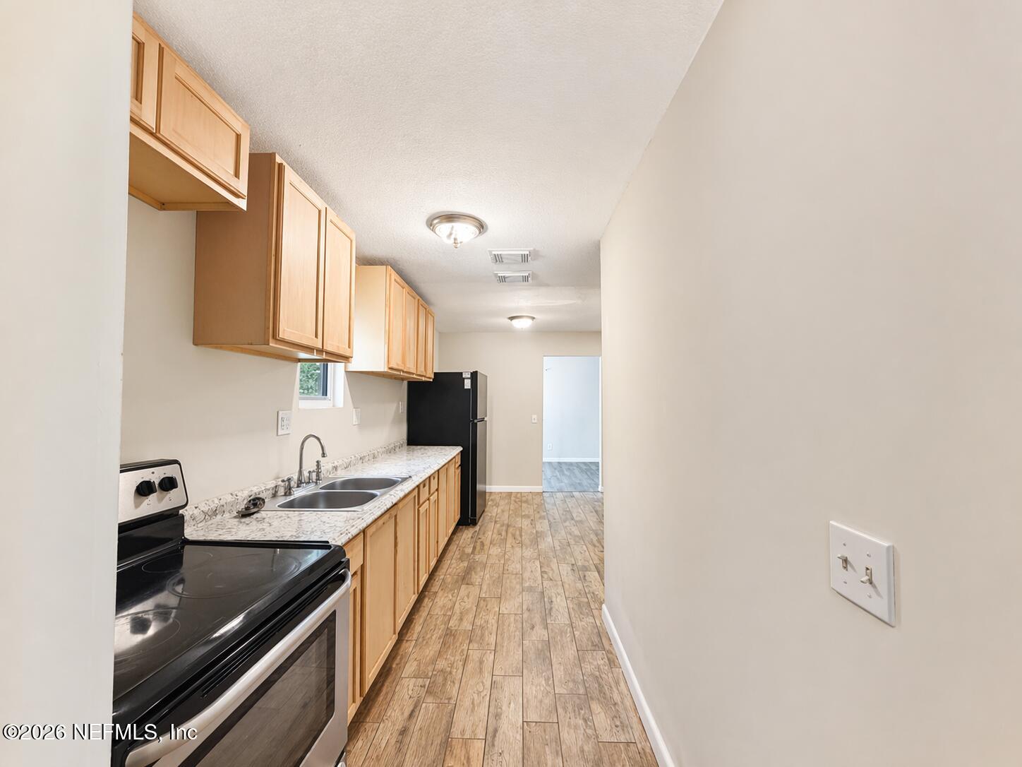 874 West 12th Street St. Augustine, FL 32084 - Photo 9 of 29 a kitchen with a sink and cabinets