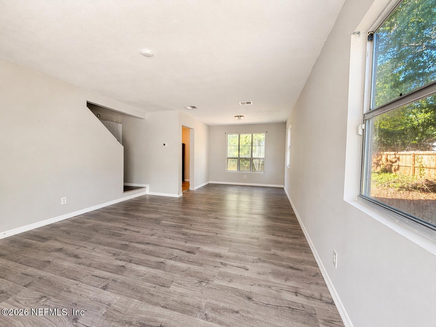 874 West 12th Street St. Augustine, FL 32084 - Photo 10 of 29 a view of an empty room with wooden floor and a window