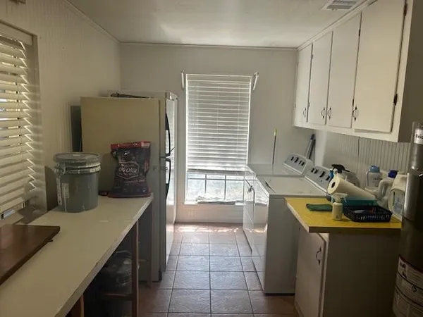 a kitchen with a sink and a stove top oven