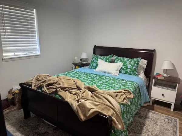 a bedroom with a bed and a window