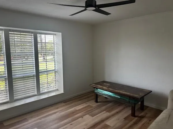 a bench sitting in a room next to a window