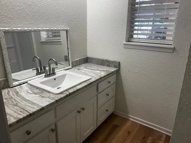 a bathroom with a sink and a mirror