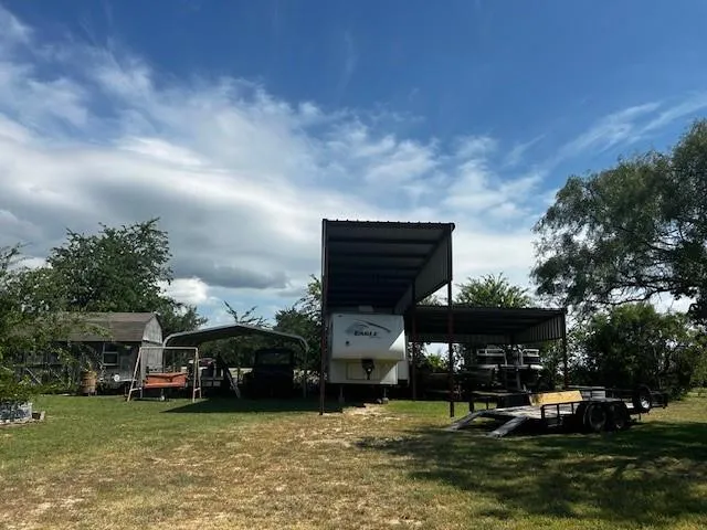 a view of a building with cars parked in front of house