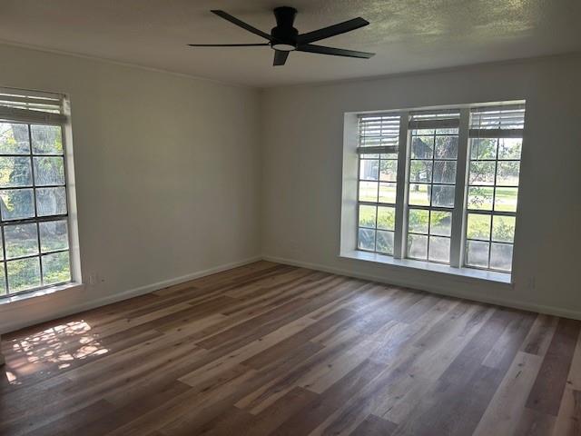 320 County Road 401 Comanche, TX 76442 - Photo 9 of 26 a view of an empty room with wooden floor and a window