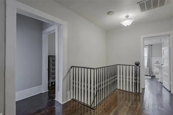 a view of hallway with wooden floor