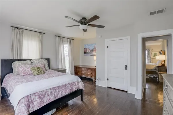 a bedroom with a bed closet and a fireplace
