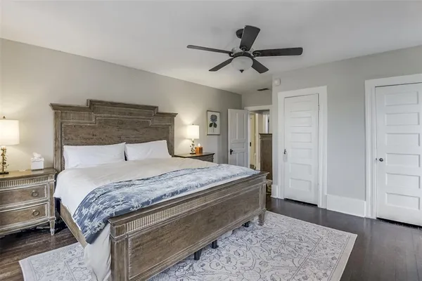 a bedroom with a large bed and a chandelier