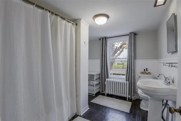 a bathroom with a sink a mirror and a toilet