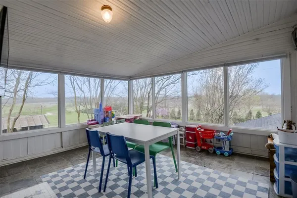 a dining room with a table and chairs