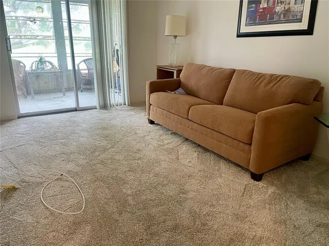 a living room with furniture and a floor to ceiling window