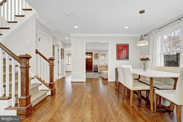 a view of a livingroom with furniture wooden floor and staircase