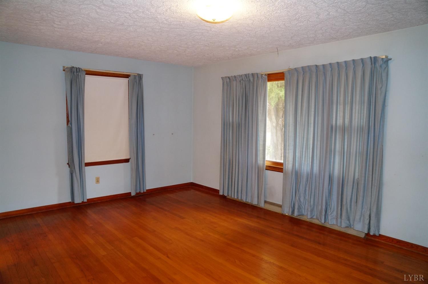 2106 Railview Road Gladys, VA 24554 - Photo 3 of 20 an empty room with wooden floor and windows