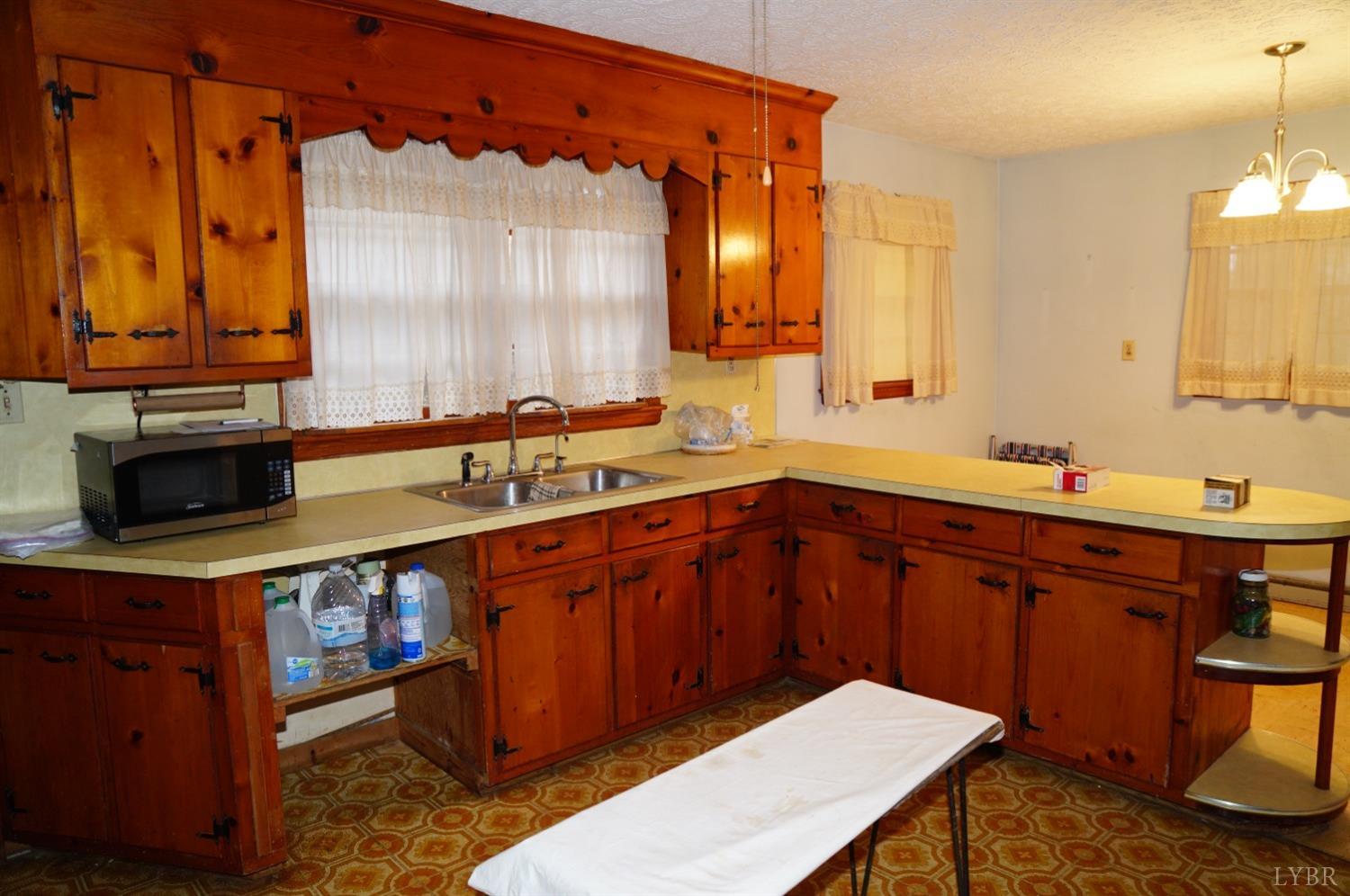 2106 Railview Road Gladys, VA 24554 - Photo 5 of 20 a kitchen with a sink and wooden cabinets