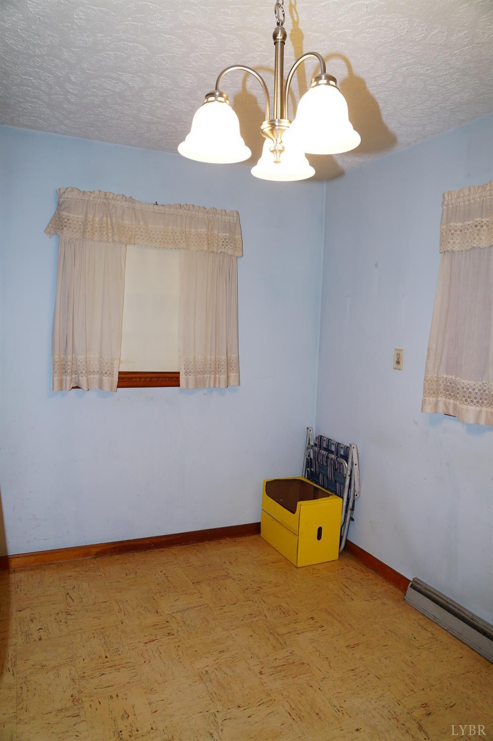 2106 Railview Road Gladys, VA 24554 - Photo 7 of 20 a room with a table and a chandelier