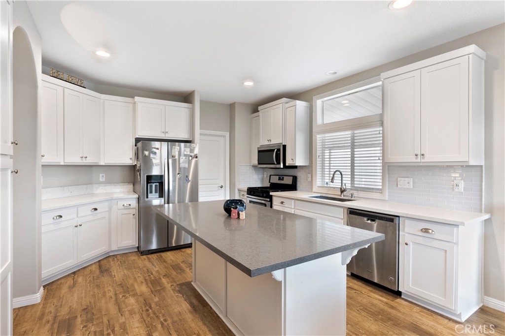 1194 Cambridge Square Corona, CA 92882 - Photo 1 of 1 a kitchen with white cabinets and stainless steel appliances