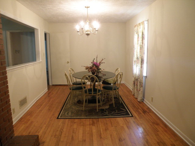 373 Greene Settlement Road Gray, GA 31032 - Photo 22 of 34 a view of a dining room with furniture and wooden floor