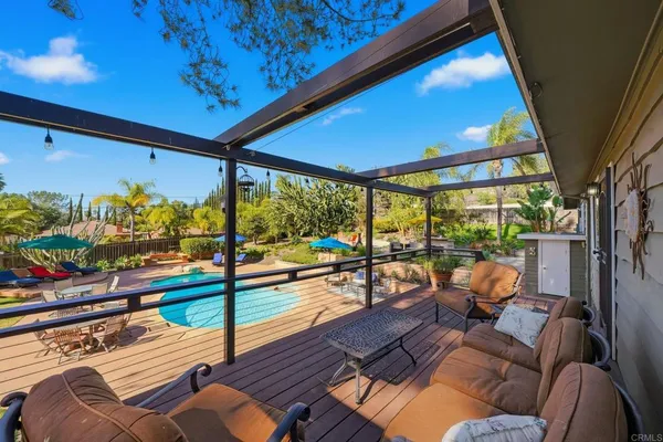 an outdoor space with swimming pool and furniture