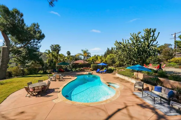 a view of a backyard with sitting area and furniture