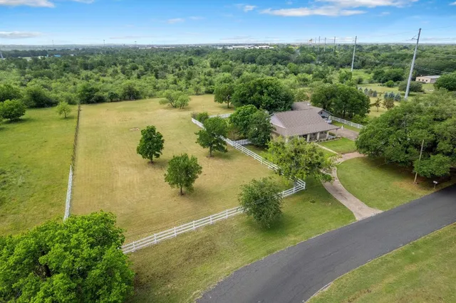 an aerial view of residential houses with outdoor space and lake view