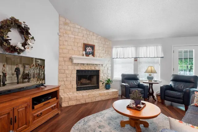 a living room with furniture and a fireplace
