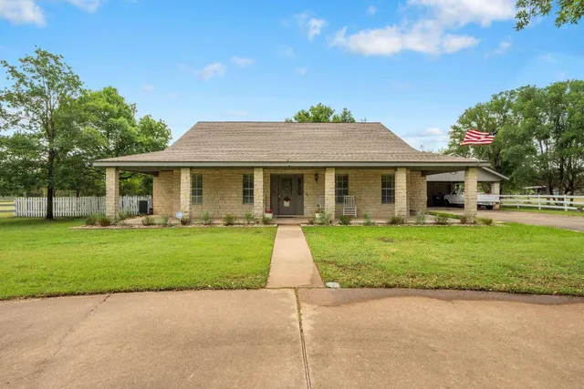a front view of a house with a garden