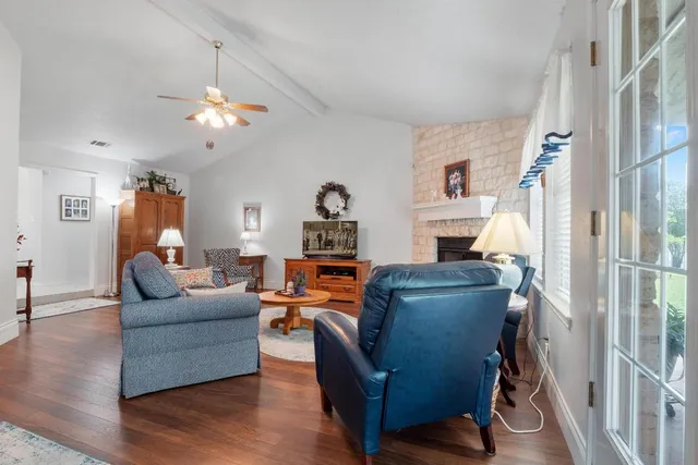 a kitchen with stainless steel appliances granite countertop a sink a stove and a refrigerator