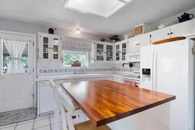 a kitchen with stainless steel appliances a stove a sink and a refrigerator