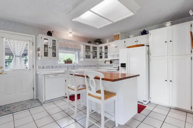 a kitchen with a white cabinets and white appliances