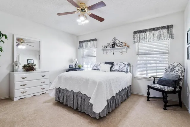 a bedroom with bed and a chandelier