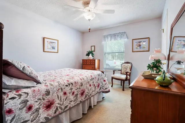 a bedroom with a bed and a dresser in it