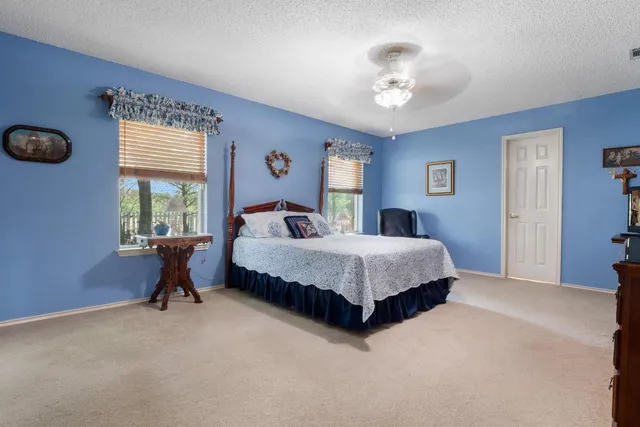 a bedroom with bed and a chandelier