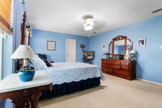 a bedroom with a large bed and a window