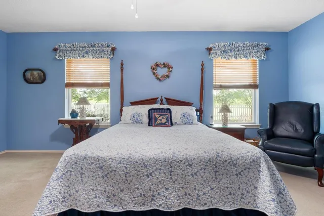 a bathroom with a tub a sink and mirror