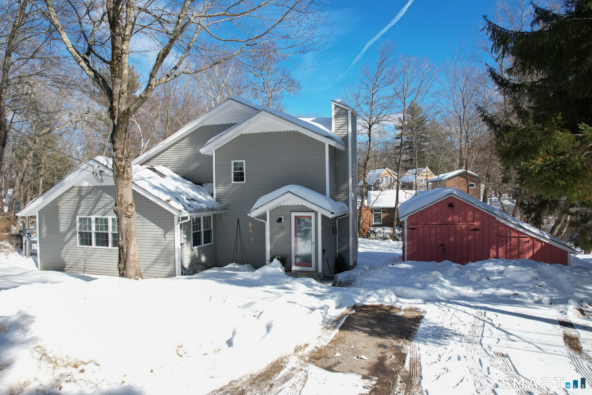 a front view of a house with a yard covered in snow