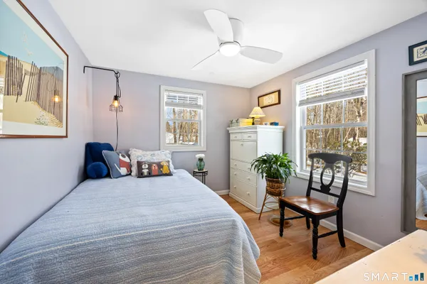 a bedroom with a bed and a large window