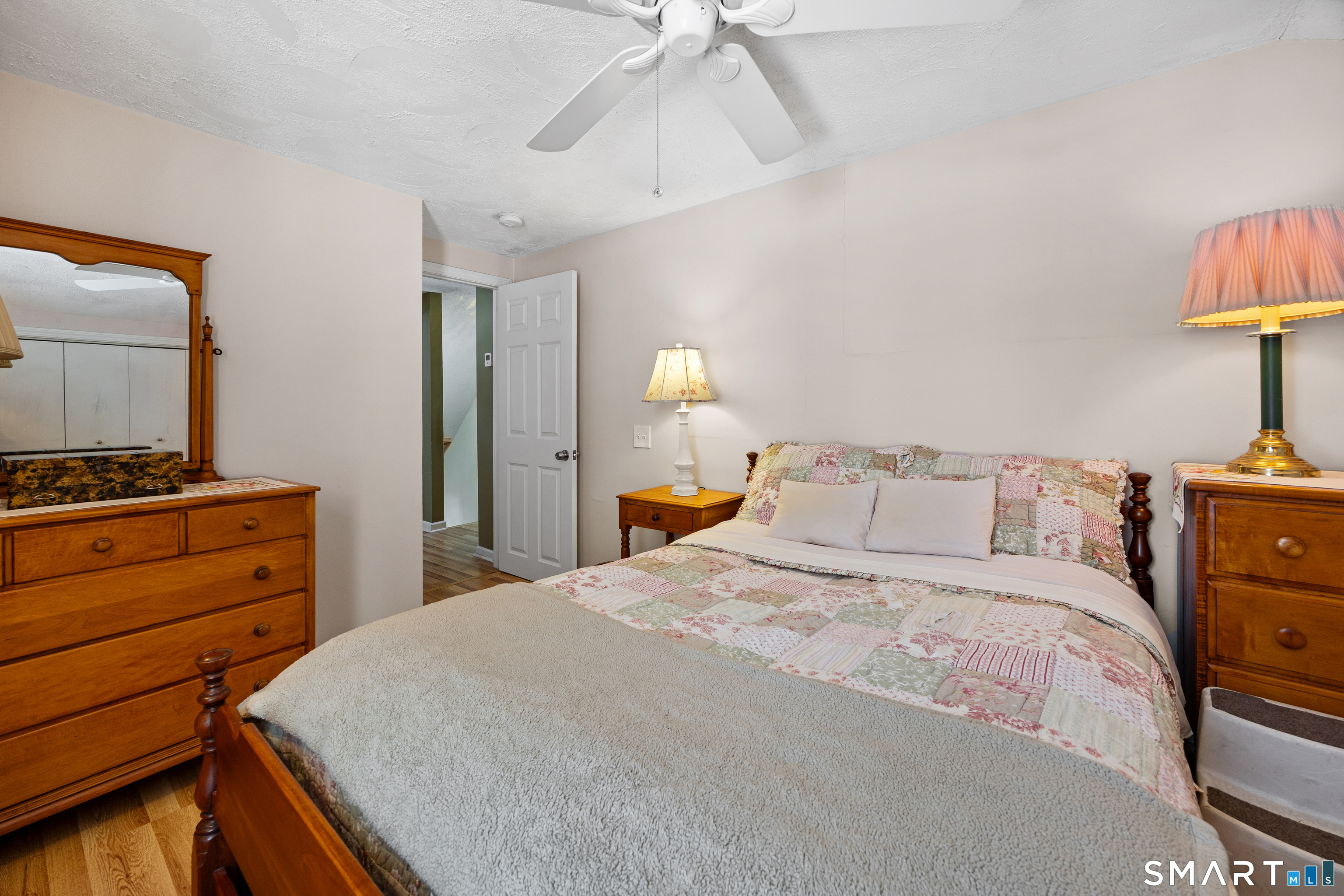 28 Davis Road New Hartford, CT 06057 - Photo 19 of 39 a bedroom with a bed and a lamp on dresser