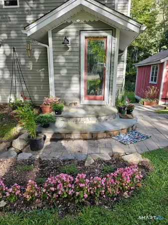 a kitchen with granite countertop a refrigerator a stove top oven and a sink