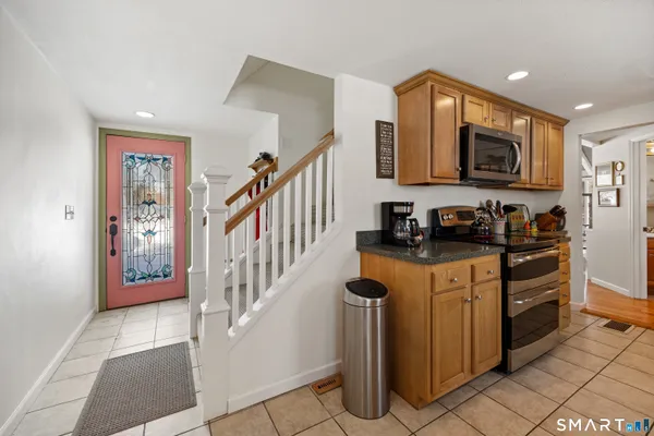 a kitchen with stainless steel appliances a sink stove and cabinets