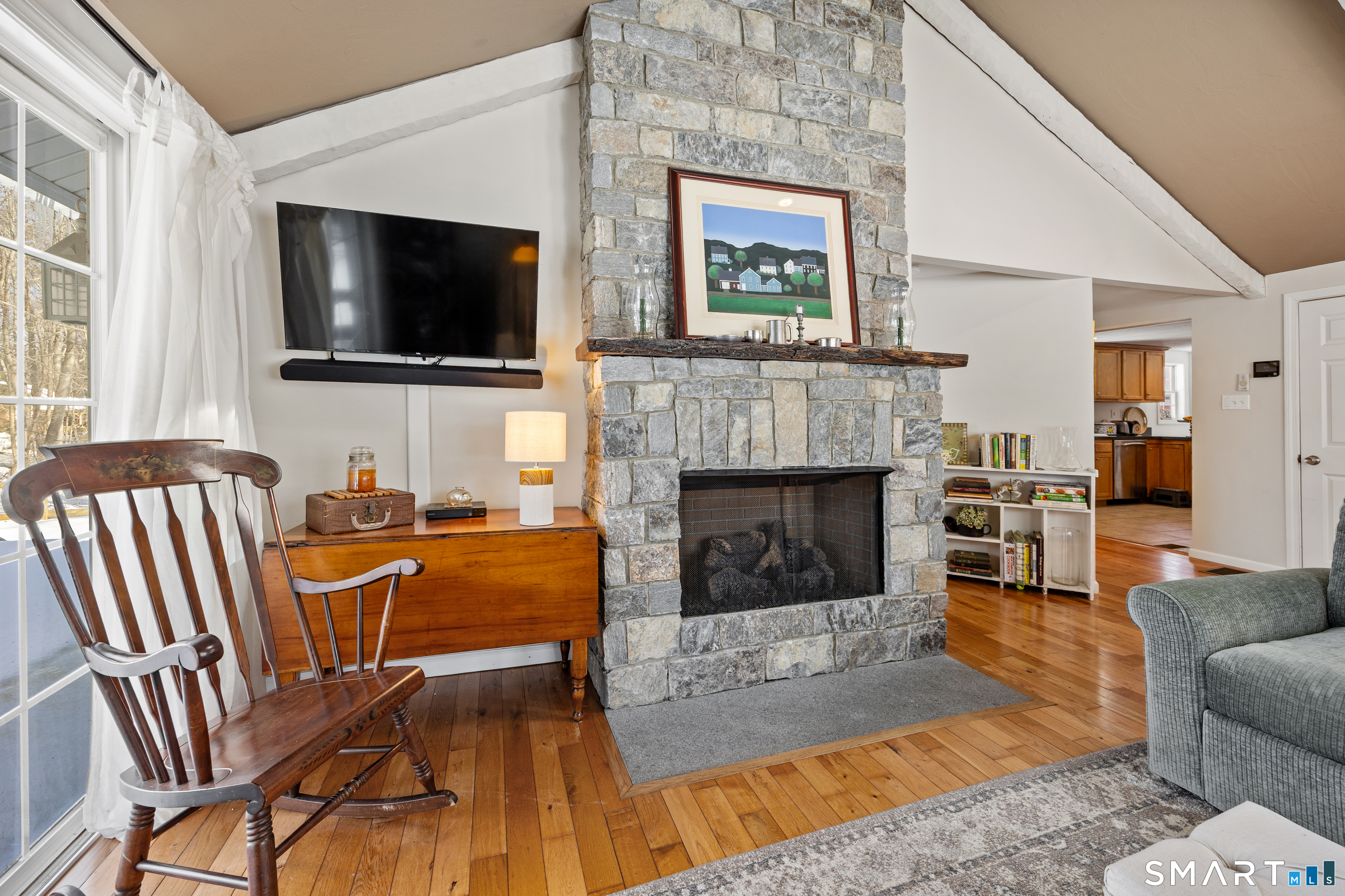 28 Davis Road New Hartford, CT 06057 - Photo 8 of 39 a living room with furniture a flat screen tv and a fireplace