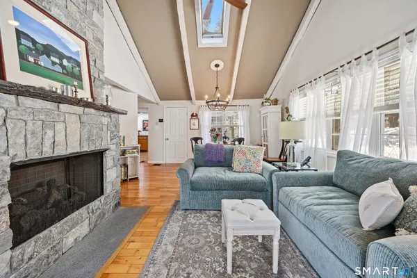 a living room with furniture a fireplace and a large window